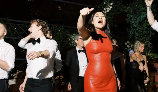 Priscilla Chan dancing in a red dress at her 40th birthday celebration alongside Mark Zuckerberg and guests